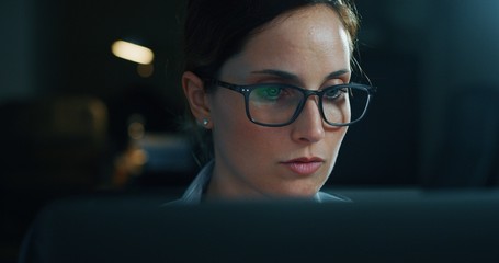 Portrait of a young beautiful business woman working with a computer in a office. Concept of technology, business and finance, economy, management, success