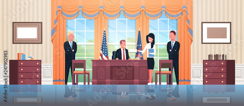Fotografía United States president sitting workplace signing law act document with female s