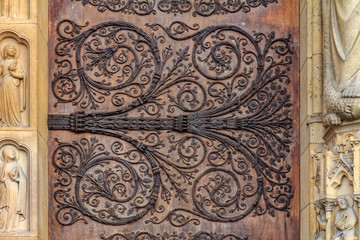 Intricate wrought iron vintage scroll work on the door hinges of Notre Dame de Paris Cathedral in Paris France forged metal hinges on the doors of Notre Dame de Paris Cathedral in Paris France