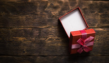 Open Square Empty Gift Box On Aged Brown Wooden Table Background With Copy Space.