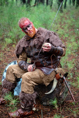 Wall Mural - Real viking sharpening his sword with a stone