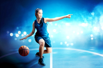 Wall Mural - Beautiful asian woman in basketball uniform dribbling the ball