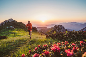 Wall Mural - man trail running on a mountain at the dask
