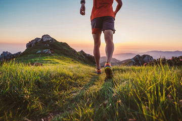 Wall Mural - man trail running on a mountain at the dask