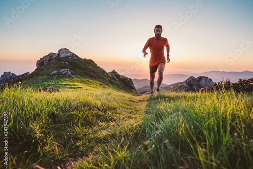 Fotografía Man trail running on a mountain at the dask