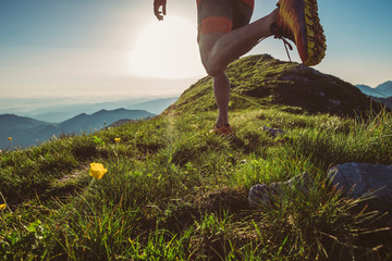 Wall Mural - man trail running on a mountain at the dask