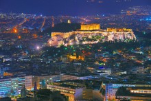 Cityscape Of Athens With Illuminated Acropolis Hill, Pathenon And Sea At Night. Athens Skyline At Night Viewed From Mt Lykavitos With Acropolis, Greece. Shot In Blue Hour.