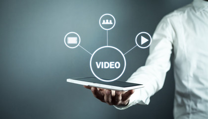 Wall Mural - man holding tablet with video sign. video marketin