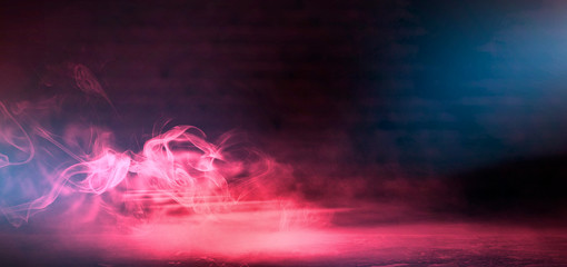 Red Smoke on a dark background. Dark empty room with rays of light, searchlight. Color correction, background.