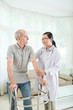 © DragonImages - Physiotherapist visiting patient