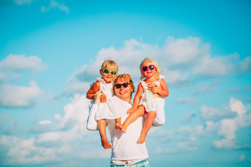 happy father with two little daughters play at sky