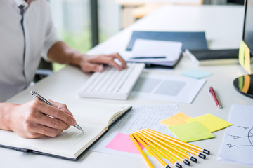 Aufkleber - Businessman working writing making note business plan and graphic designer with computer in office