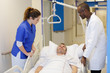 © auremar - medical team attending female patient on hospital bed