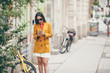 © travnikovstudio - Woman talk by her smartphone in city. Young attractive tourist outdoors in italian city