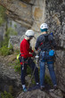 © esalienko - Two young women work with a rope on the route. Two person rope. Sport climbing.
