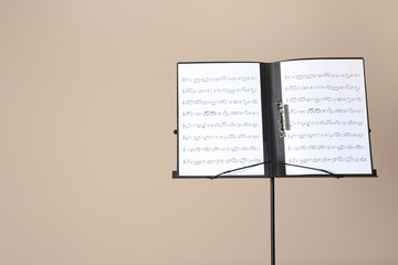 Sticker - Note stand with music sheets on color background. Space for text