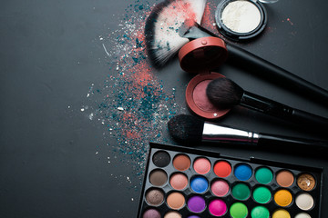 Wall Mural - Makeup cosmetics on a black background