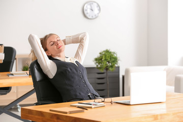 Poster - Young businesswoman relaxing in office