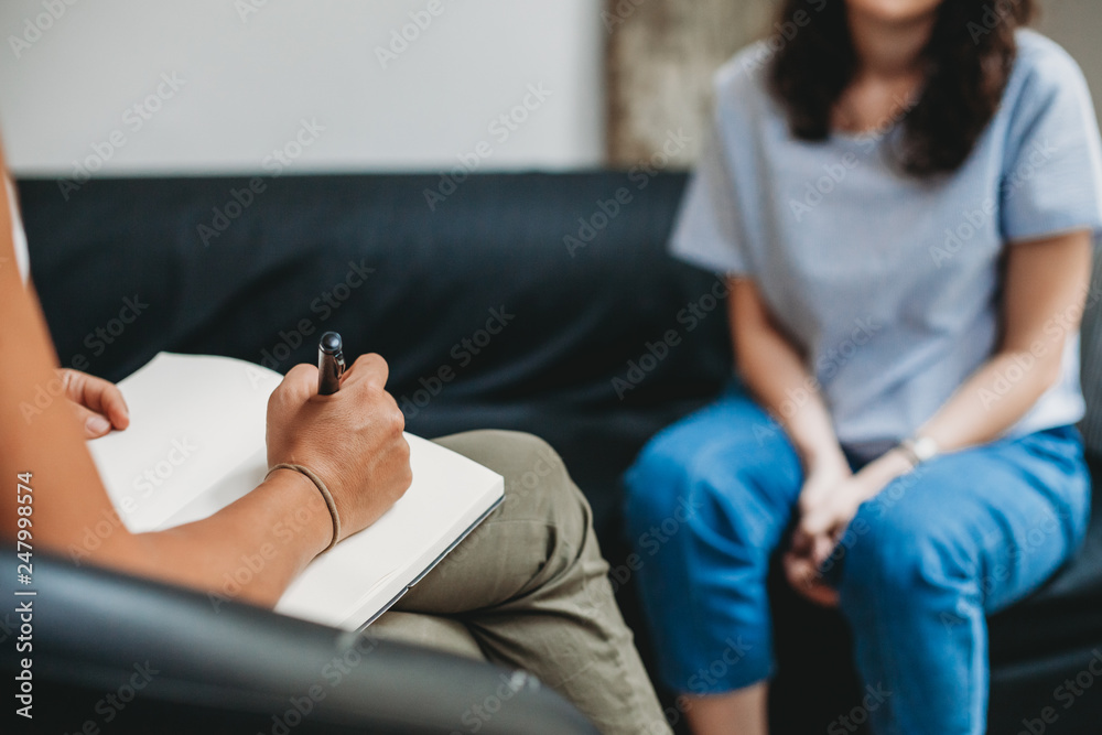 Psychotherapy session, woman talking to his psychologist in the studio - obrazy, fototapety, plakaty 