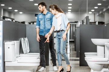 Wall Mural - Couple choosing toilet ceramics in the shop