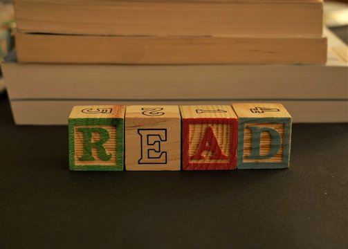 Wooden cubes forming the word Read