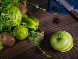 Wall Mural - Set of green fruits for healthy diet and detox: apple, lime, kiwi, mango, carambola and mint.