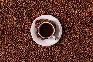 Cup of coffee on a background of coffee beans