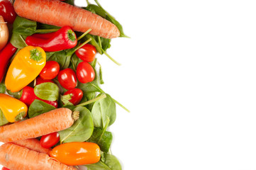 Fresh garden vegetables on a white background with space for text