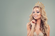 Smiling blonde woman with long curly hair, makeup and gold crown on background with copy space