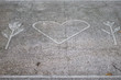 © Reinis - A symbol of Nature Love on a pavement in a park.