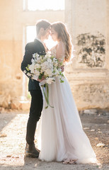 Bride and groom at wedding ceremony by the old cathedral