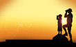 © MiaStendal - Silhouette of dad and son looking through binoculars against a sunset