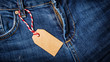 Mock up of empty brown paper price tag on blue jeans