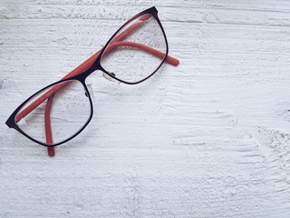 A pair of glasses on white wooden background