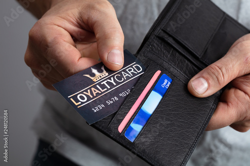 Fotomural Person Removing Loyalty Card From Wallet