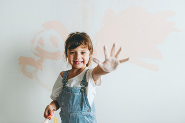 Wall Mural - Cheerful girl showing her painted hand