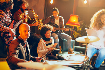 Sticker - Multicultural jazz band practicing for the gig in home studio.