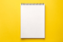 Yellow Blank Background With An Open Notebook. Office Mockup. Top View. Minimal Composition. Place For Text. Sketchbook. Concept Photo