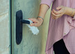Mysophobic woman opens the door with a napkin
