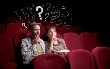 Wall Mural - Nice couple in cinema with drawn question signs around