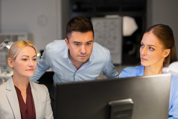 Poster - business, deadline and technology concept - coworkers with computer working late at night office