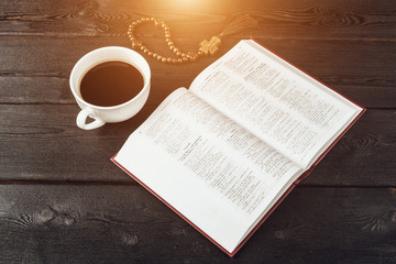 Wall Mural - Bible and a crucifix on an old wooden table. Religion concept.