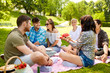 © Syda Productions - friendship, leisure and summer concept - group of happy friends eating watermelon at picnic in park