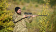 © be free - Hunter hold rifle. Bearded hunter spend leisure hunting. Focus and concentration of experienced hunter. Hunting masculine hobby concept. Man brutal gamekeeper nature background. Regulation of hunting