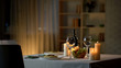 © motortion - Romantic dinner table setting, wine glasses and fresh salad in bowl, home date