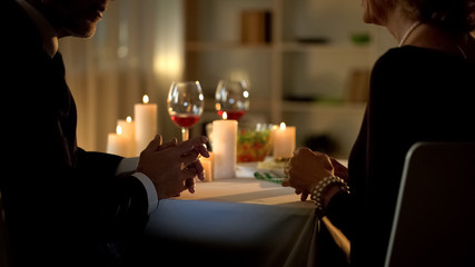 Stylish retired couple enjoying romantic dinner in restaurant, communication