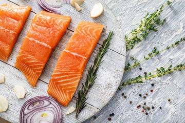 Raw salmon fillet on wooden board