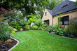 © Mint Images - House and Landscaped Yard