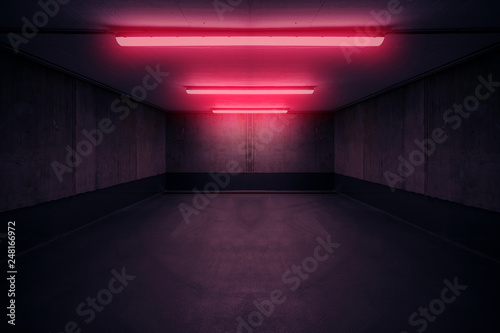 Fotografía dark underground room with red neon light in basement or parking lot -