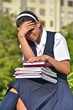 © dtiberio - Unhappy Catholic Colombian Female Student Wearing School Uniform With Books